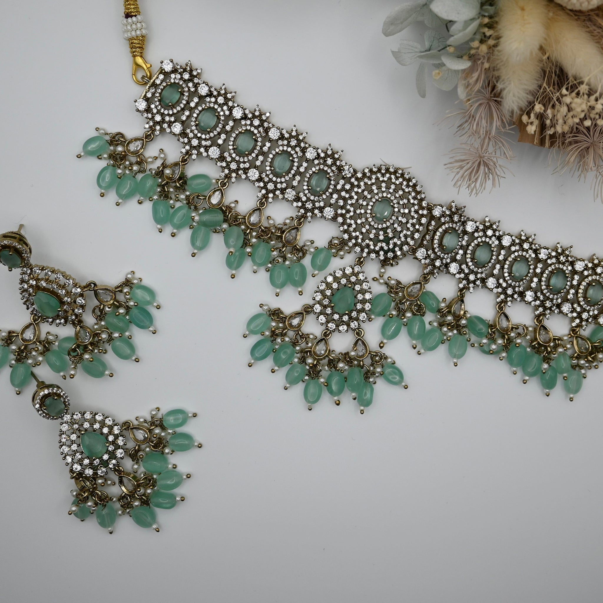 Leocadia- heavy CZ choker with mint green monalisa stone and matching earrings