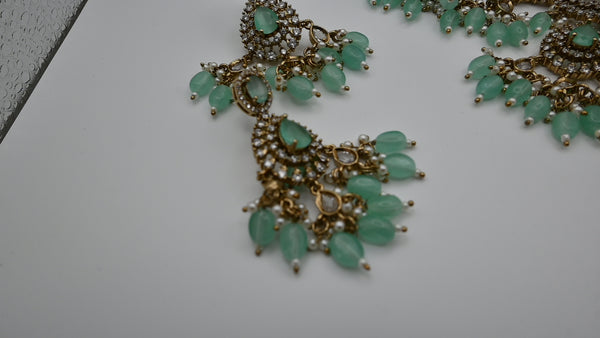 Leocadia- heavy CZ choker with mint green monalisa stone and matching earrings