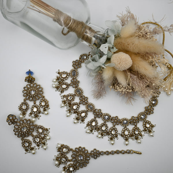 Kavia- necklace, earrings and mangtika with Polki clear stones and mehndi coloured plating